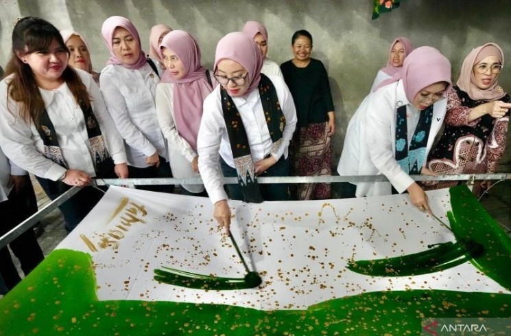 Penasihat I DWP Kemensos Fatma Saifullah Yusuf (kanan) didampingi Penasihat II DWP Kemensos Intan Agus Jabo mewarnai kain sebagai dasar kerajinan batik di Blitar, Jawa Timur, Minggu (22/6/2025). ANTARA/HO-Biro Humas Kemensos
